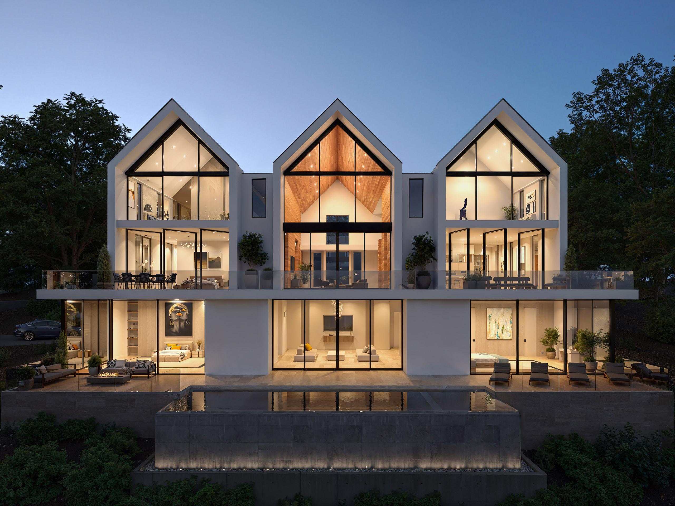 Сучасний будинок з трьома двосхилими дахами та панорамними вікнами.